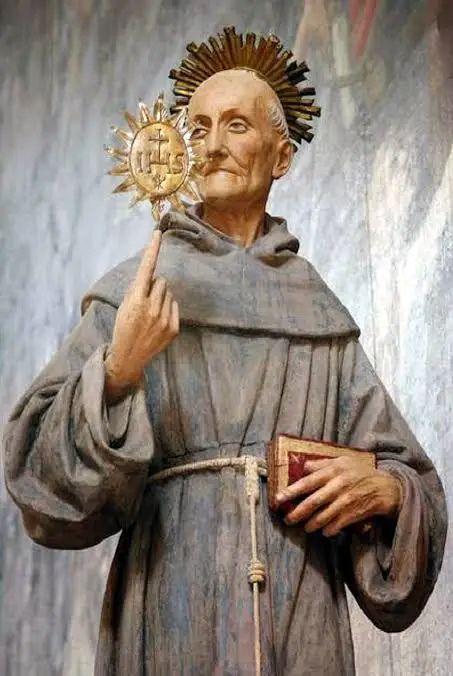 Portrait of St. Bernardine of Siena in Franciscan habit holding the IHS monogram with radiant sun, depicting the 15th-century preacher and patron of the Holy Name of Jesus