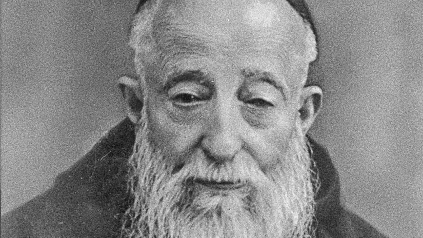 Saint Leopold Mandic dressed in a Capuchin Franciscan habit while hearing confessions in his small confessional room in Padua, Italy.