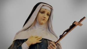 Portrait of St. Rita of Cascia in Augustinian habit holding a crucifix and roses, depicting the patroness of impossible causes with her characteristic forehead wound symbolizing partial stigmata