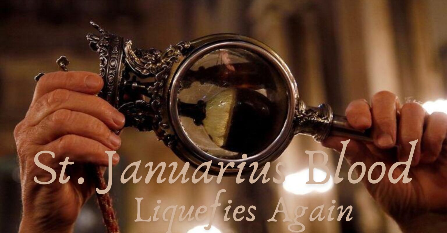 Close-up of hands holding a glass reliquary containing the liquefied blood of St. Januarius during a church ceremony.