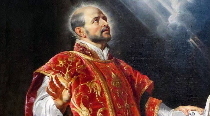 Saint Ignatius of Loyola holding the Jesuit Constitutions in prayer